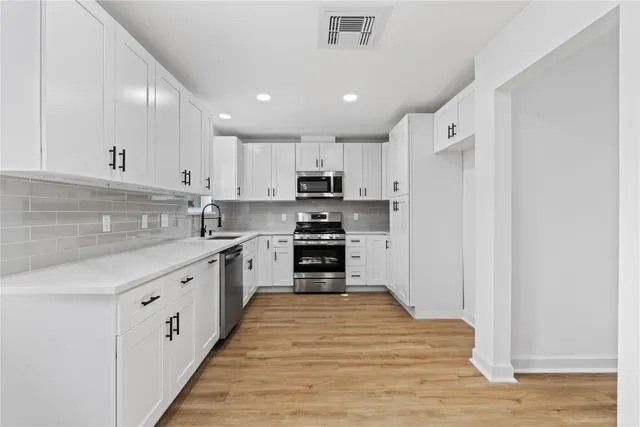 a view of a kitchen with a sink and a window