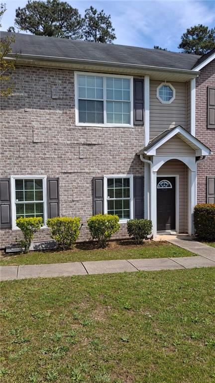 a front view of a house with a yard