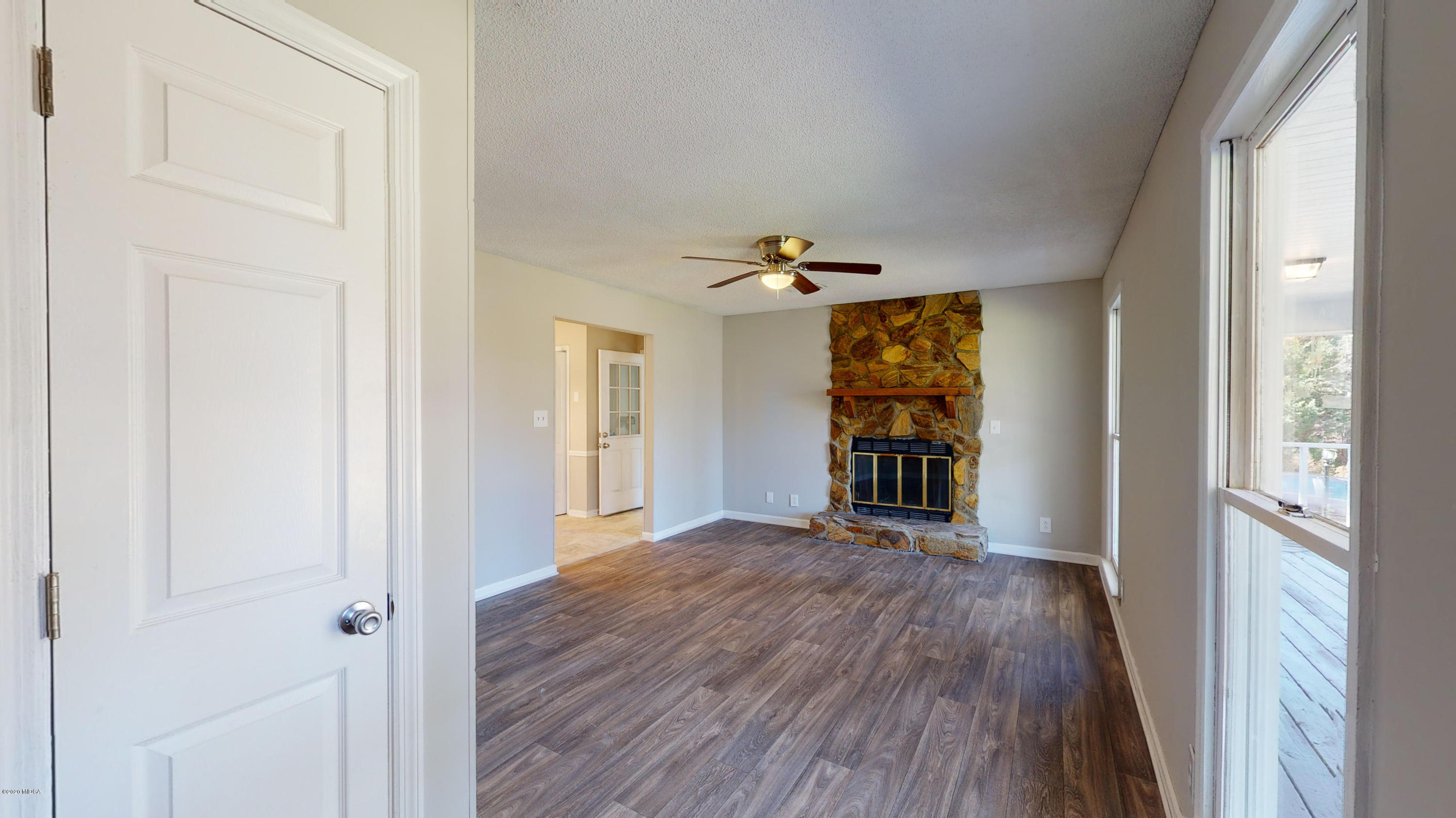 7228 Columbus Road Lizella, GA 31052 - Photo 4 of 41 a view of a hallway with wooden floor and a living room