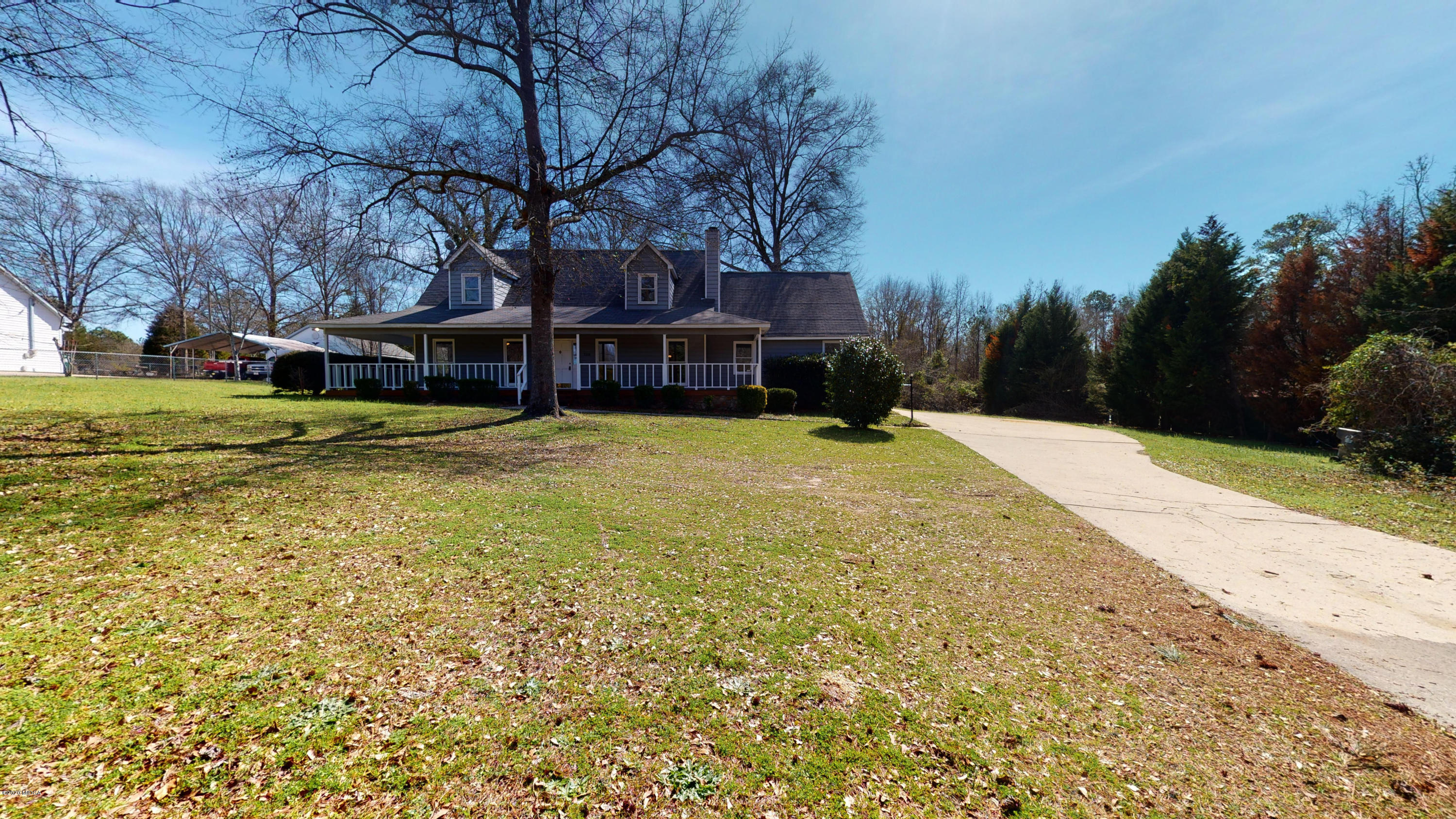 7228 Columbus Road Lizella, GA 31052 - Photo 36 of 41 a view of a house with a yard covered with snow and trees