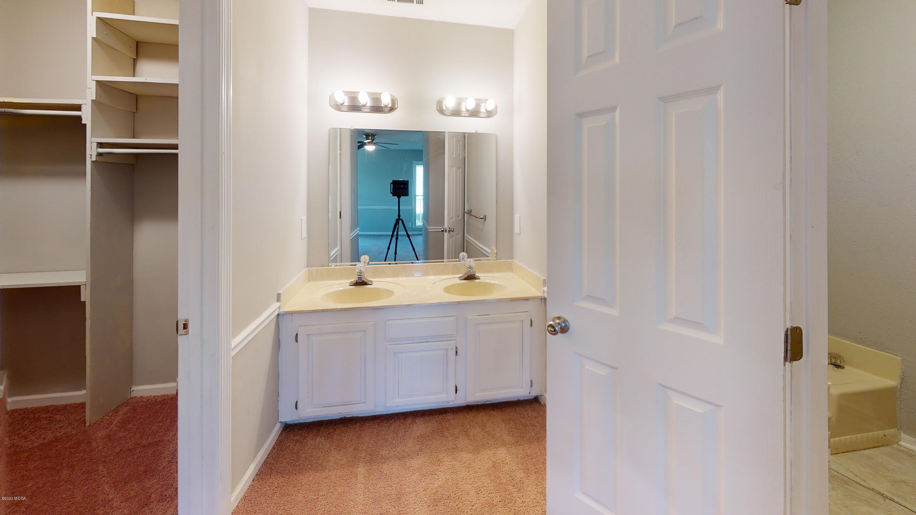 7228 Columbus Road Lizella, GA 31052 - Photo 40 of 41 a bathroom with a double vanity sink and mirror