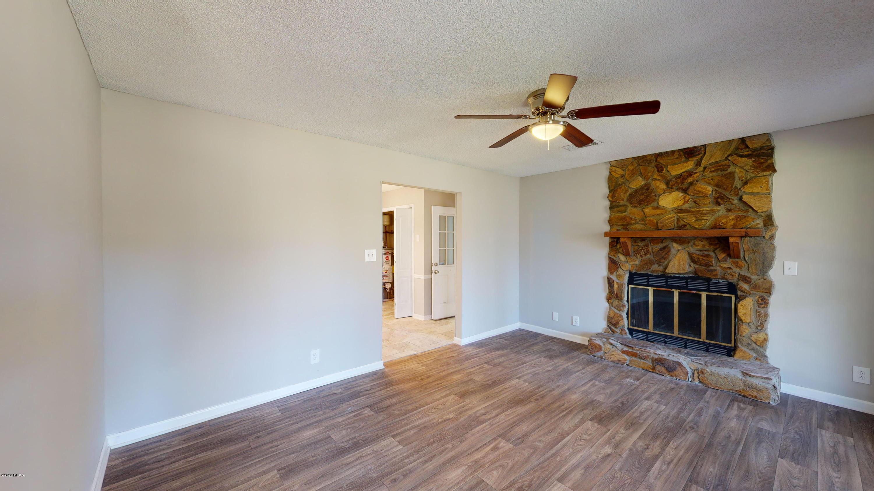 7228 Columbus Road Lizella, GA 31052 - Photo 5 of 41 a view of a livingroom with wooden floor and a ceiling fan