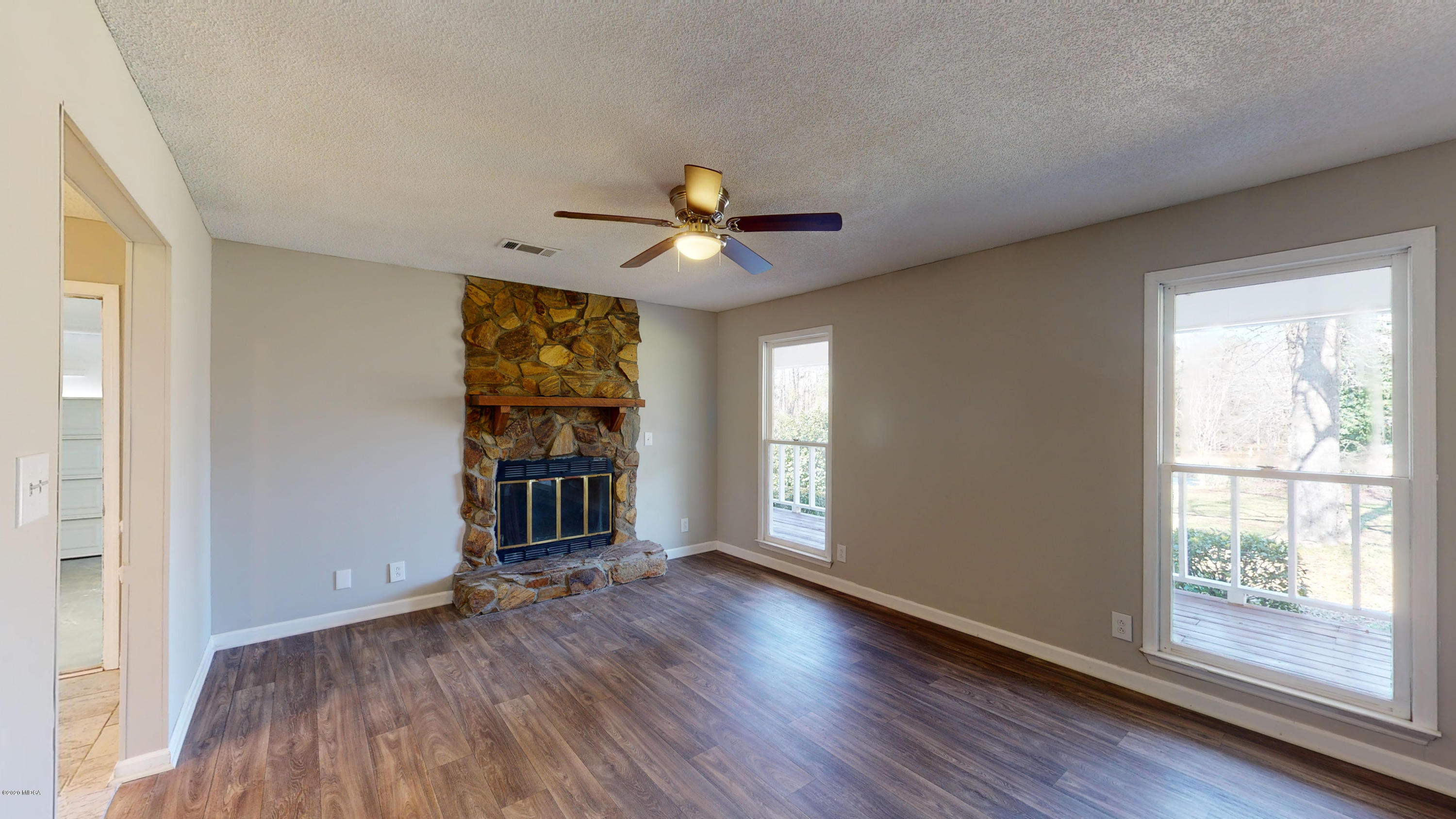 7228 Columbus Road Lizella, GA 31052 - Photo 6 of 41 a view of an empty room with window and wooden floor