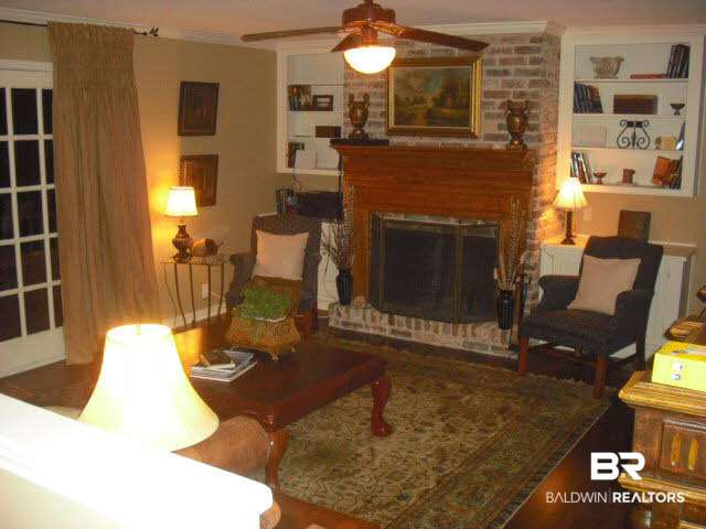 6156 Brandy Run Road South Mobile, AL 36608 - Photo 7 of 16 Enter from Foyer to spacious Main Den with Hardwood Floors, Custom Built-ins, Fireplace, & 15-light doors that exit onto spacious Upper Deck.