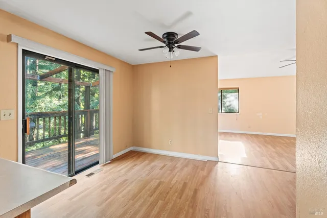 a view of a livingroom with a ceiling fan and window