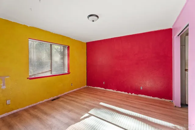 a view of a room with wooden floor and windows