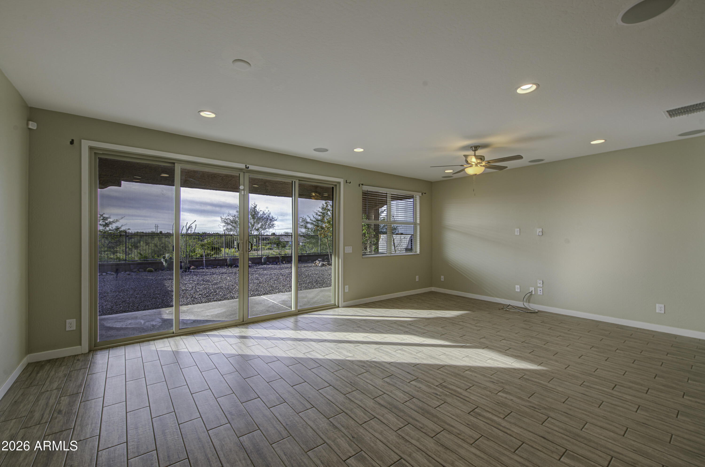 12409 East Soloman Road Gold Canyon, AZ 85118 - Photo 11 of 48 an empty room with wooden floor and windows