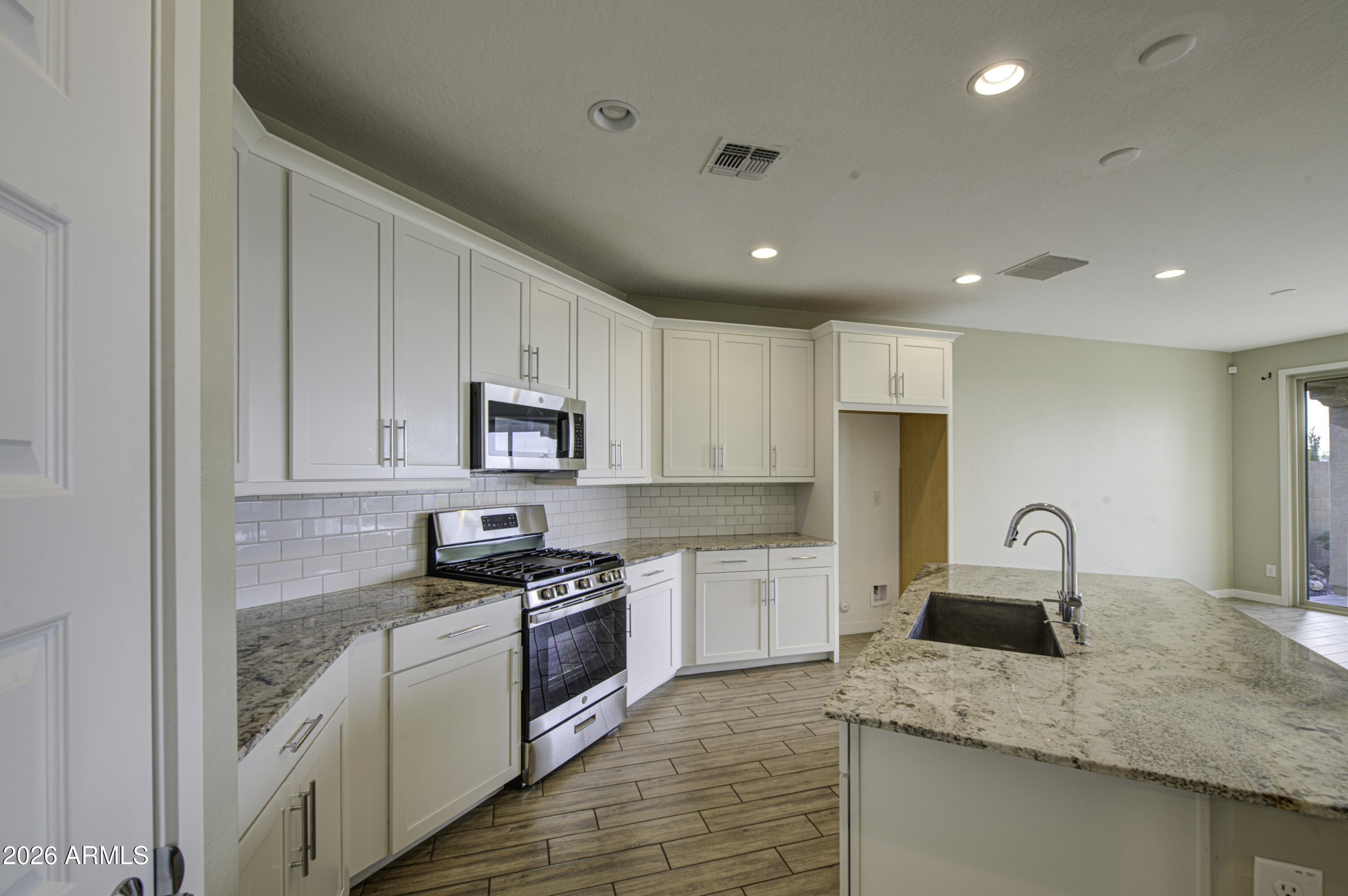 12409 East Soloman Road Gold Canyon, AZ 85118 - Photo 16 of 48 a kitchen with granite countertop a sink stainless steel appliances and cabinets