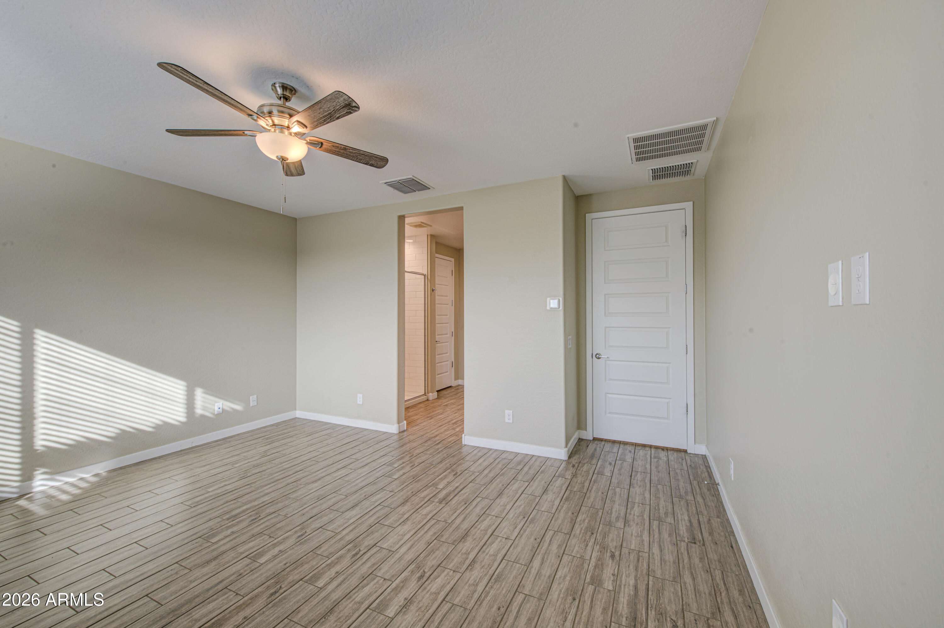 12409 East Soloman Road Gold Canyon, AZ 85118 - Photo 19 of 48 a view of an empty room with wooden floor