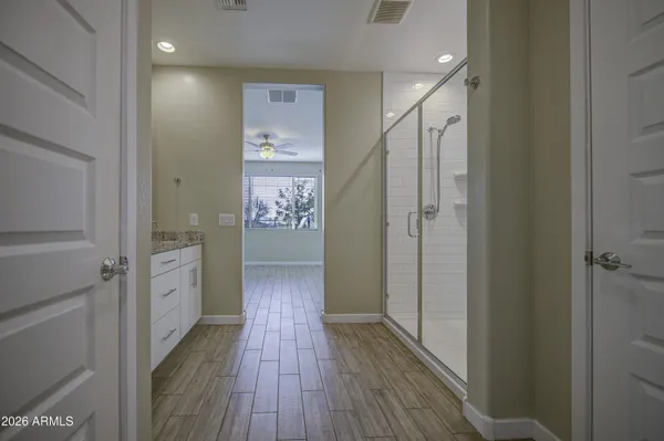 a view of a hallway with wooden floor