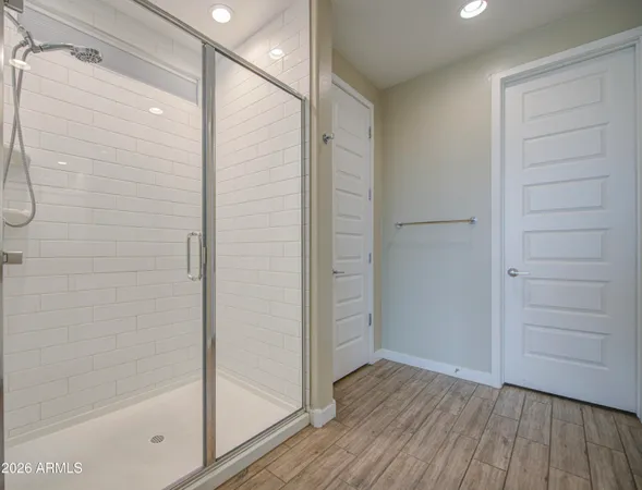 a bathroom with a shower and a glass door