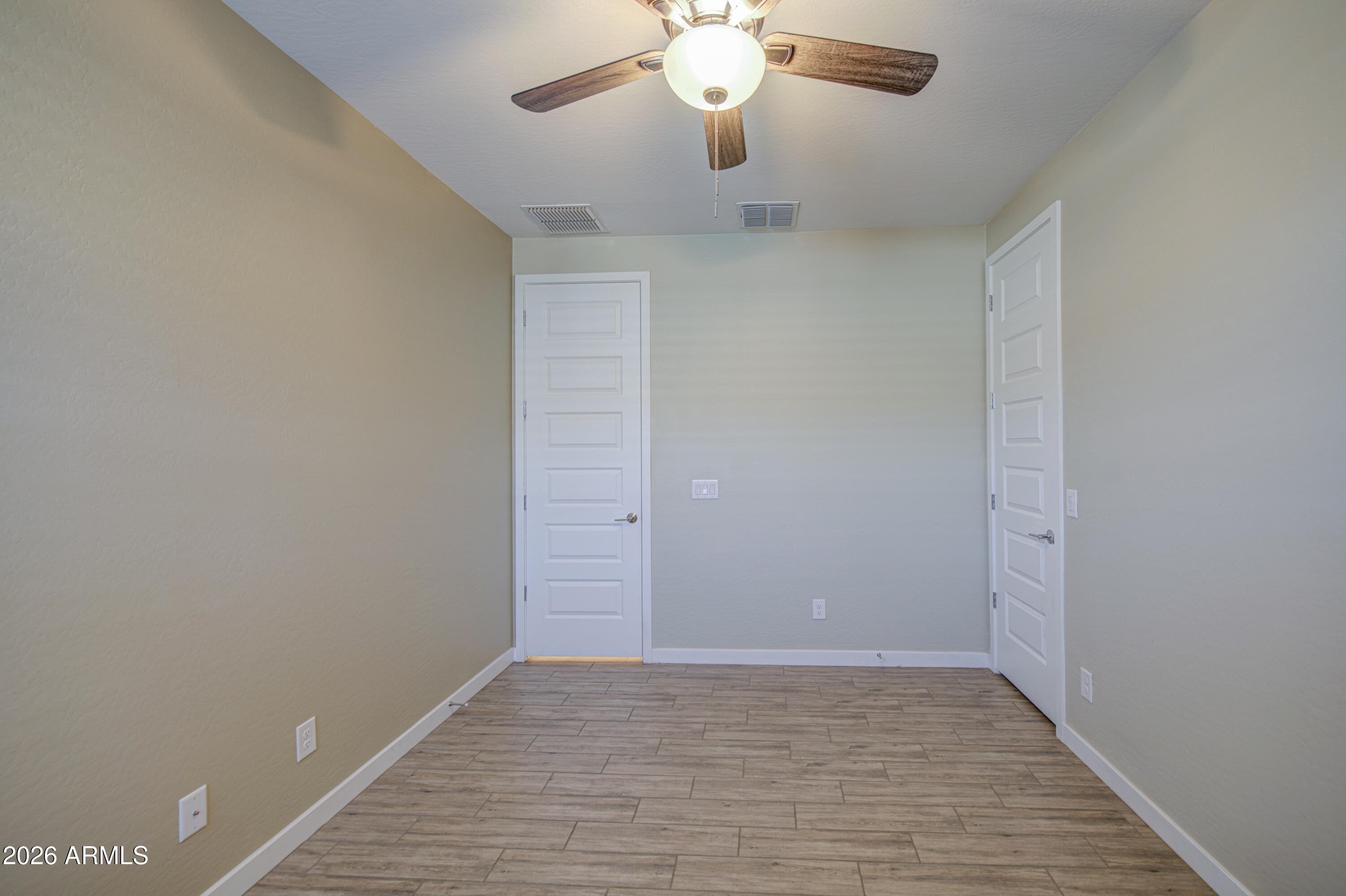 12409 East Soloman Road Gold Canyon, AZ 85118 - Photo 33 of 48 a view of an empty room with wooden floor