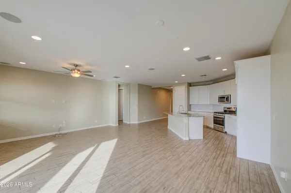 an empty room with kitchen and a sink