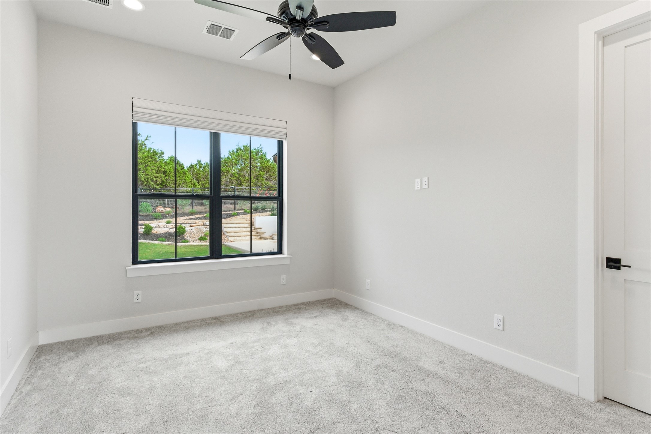 27619 Sunset Loop Garden Ridge, TX 78266 - Photo 22 of 39 Soft carpeting pairs with a wide window framing peaceful backyard views in this quiet space.