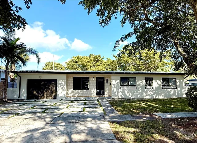 a front view of a house with yard patio and fire pit
