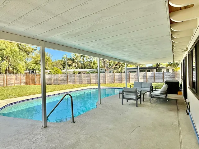 a view of a swimming pool with outdoor seating