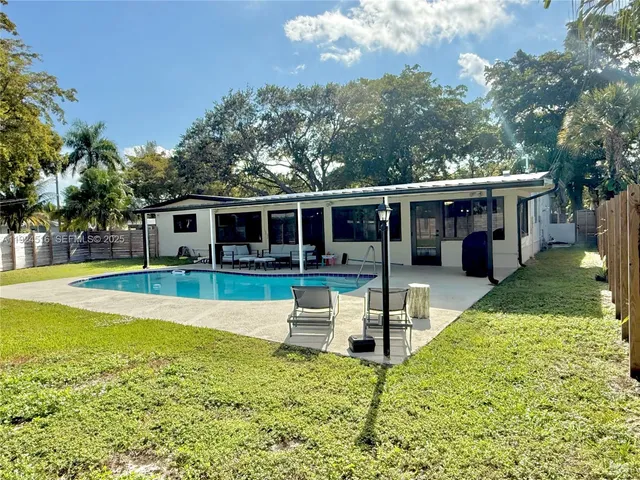 a view of house with swimming pool and view of a swimming pool