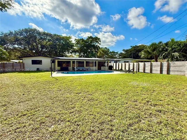 a view of a swimming pool with an outdoor space and seating area