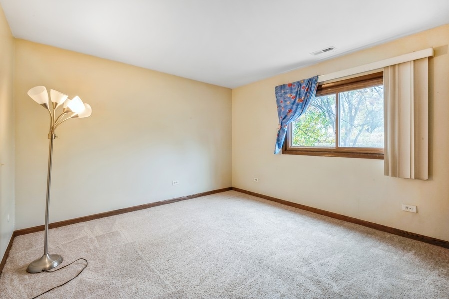 6027 103rd Street, Unit 1B Chicago Ridge, IL 60415 - Photo 8 of 9 a view of an empty room with windows