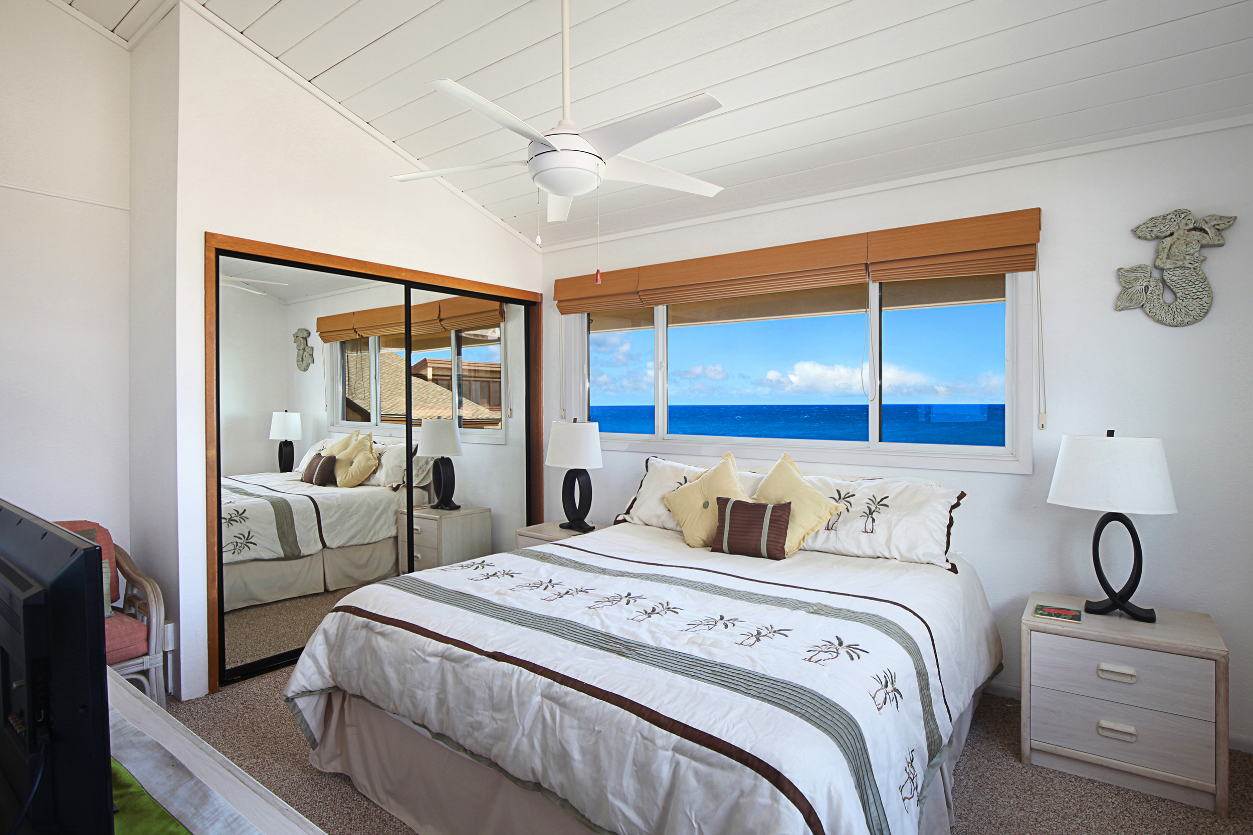 1661 Pee Road, Unit IIA312 Koloa, HI 96756 - Photo 9 of 30 a bedroom with a balcony a bed and a mirror