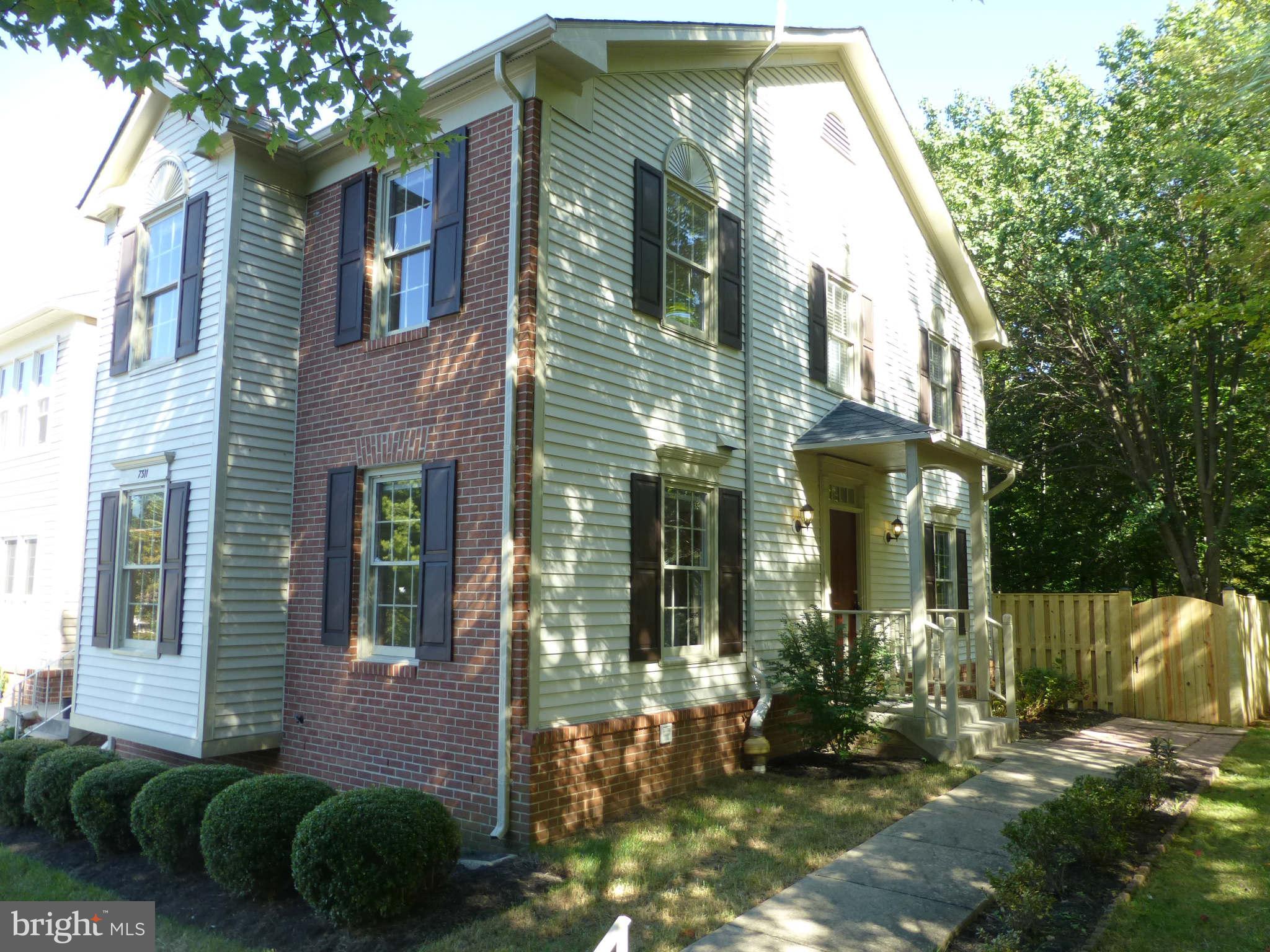 7311 Treetop Hill Lane Springfield, VA 22152 - Photo 1 of 26 a view of brick house with a yard