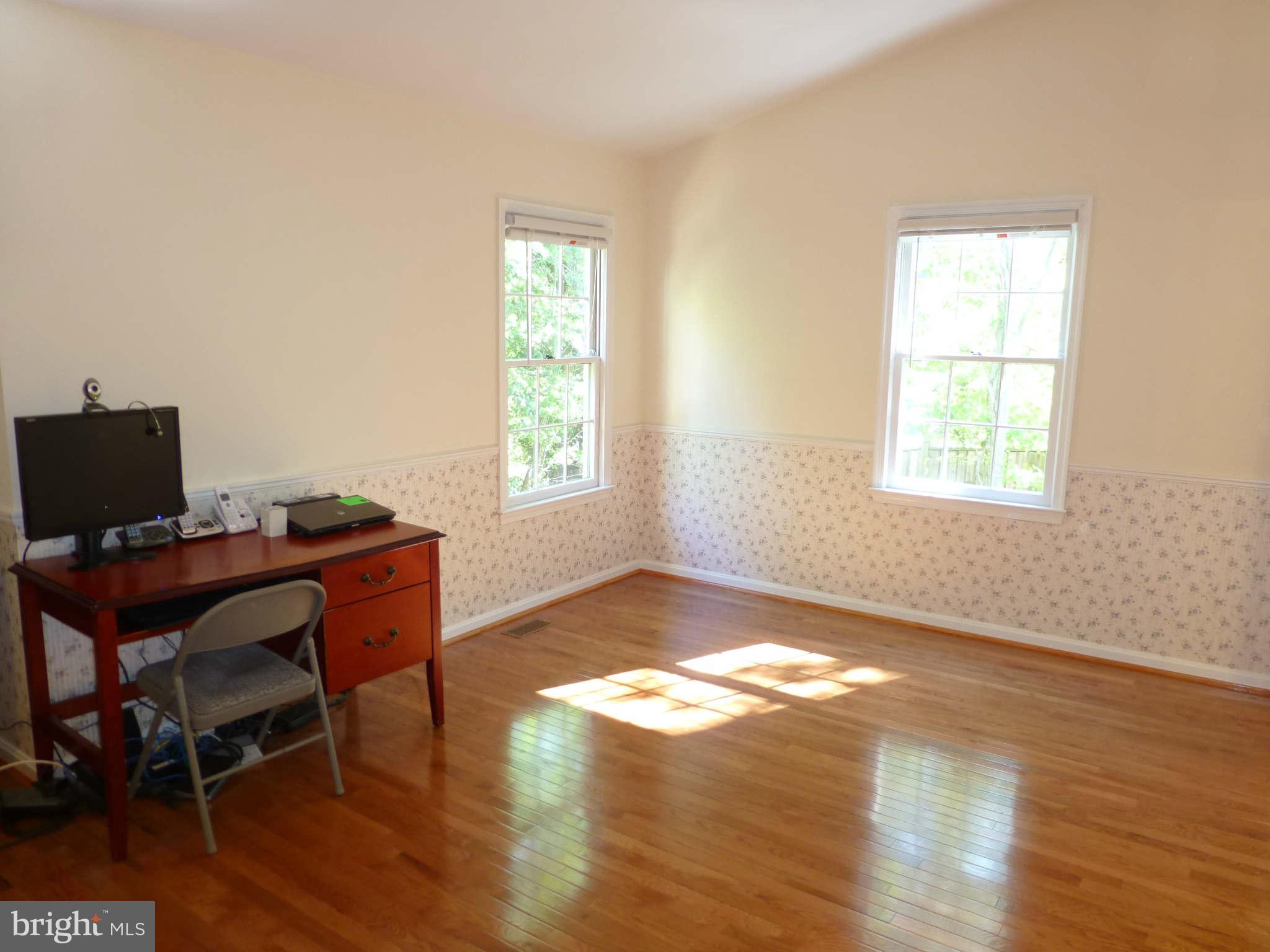 7311 Treetop Hill Lane Springfield, VA 22152 - Photo 13 of 26 a view of a workspace with furniture and a window