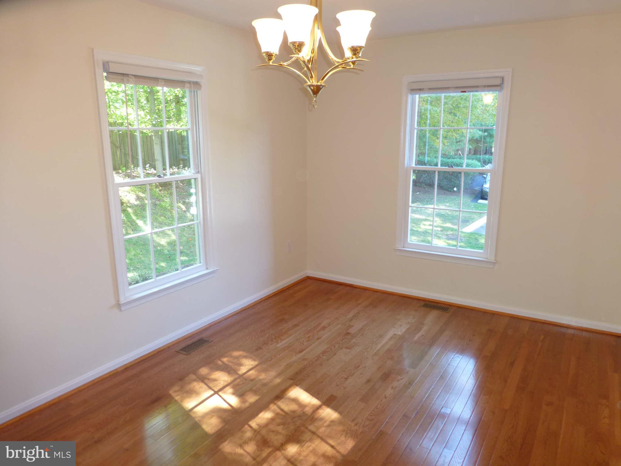 7311 Treetop Hill Lane Springfield, VA 22152 - Photo 3 of 26 a view of an empty room with wooden floor and a window