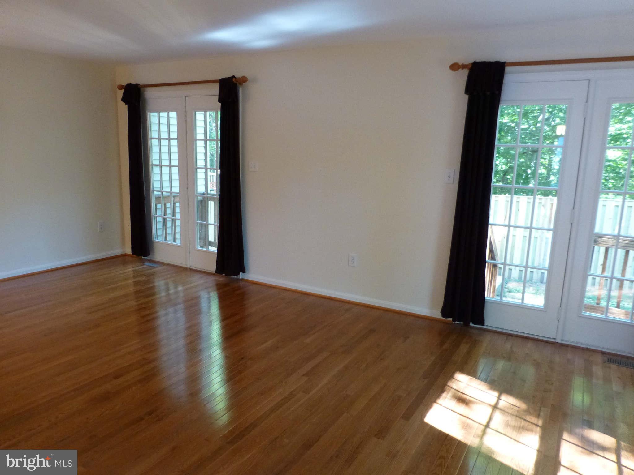 7311 Treetop Hill Lane Springfield, VA 22152 - Photo 5 of 26 a view of an empty room with wooden floor and a window
