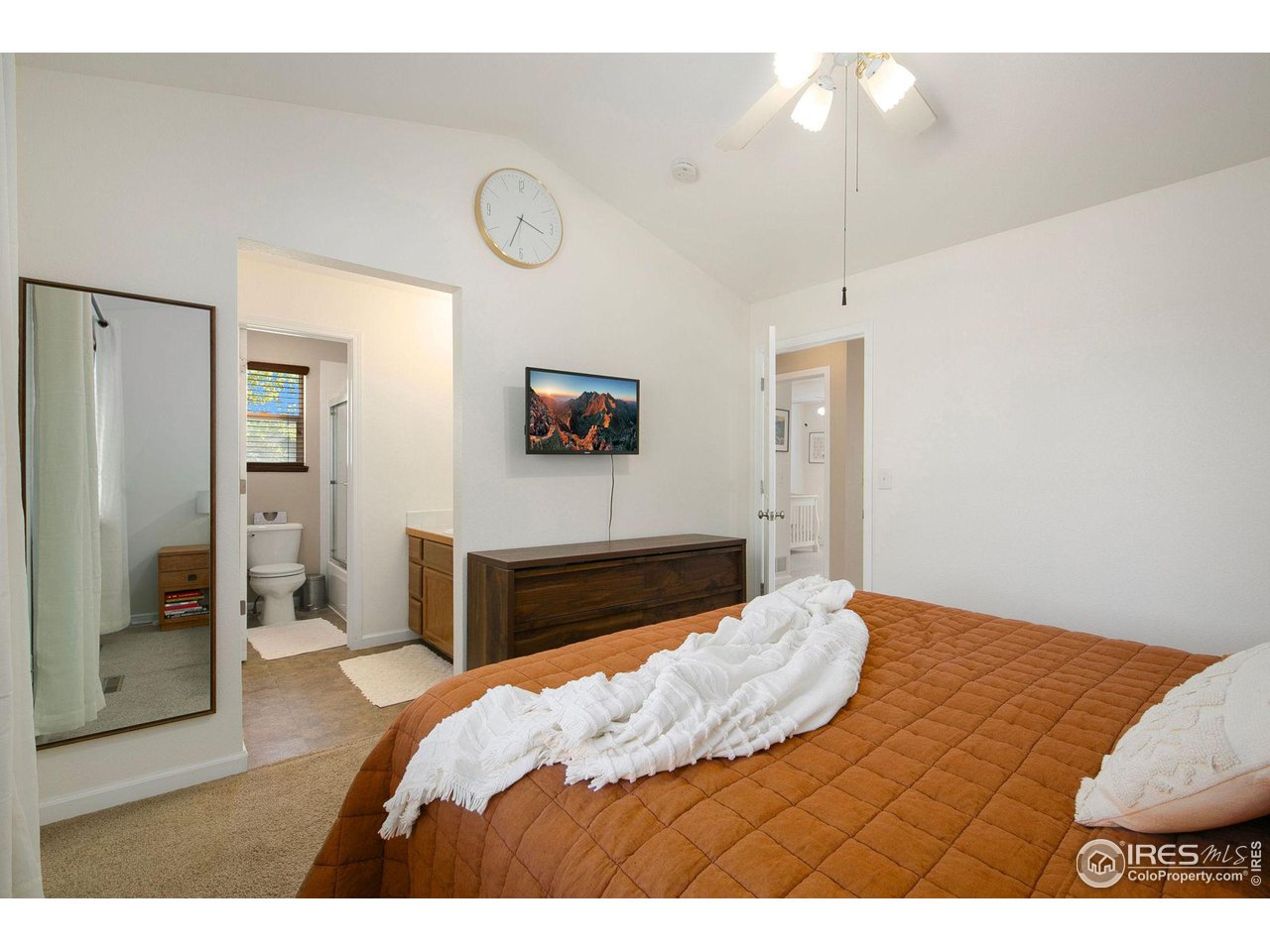 1138 Argento Drive Fort Collins, CO 80521 - Photo 15 of 25 a bedroom with a bed and a chandelier