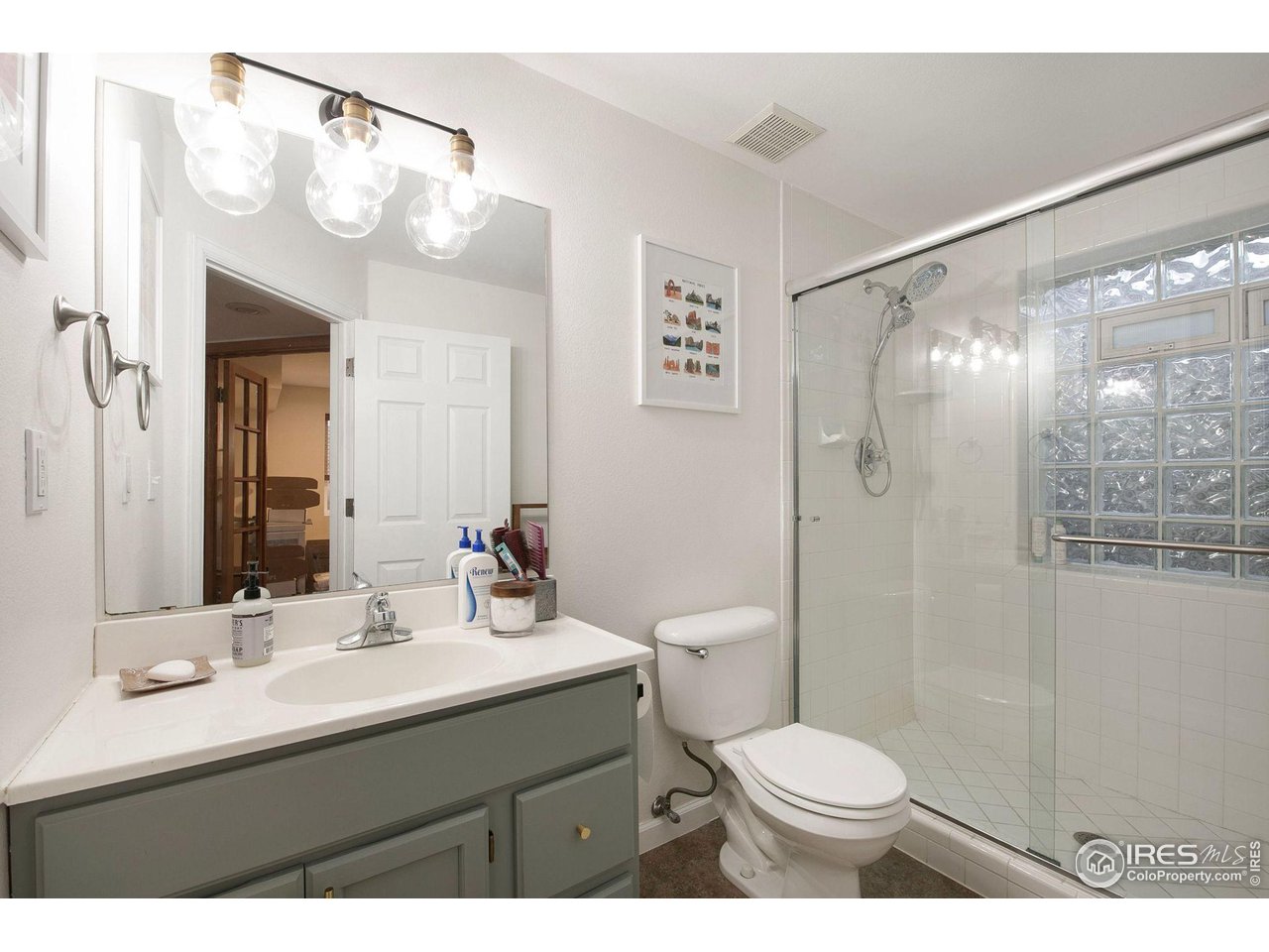 1138 Argento Drive Fort Collins, CO 80521 - Photo 21 of 25 a bathroom with a sink vanity mirror and toilet