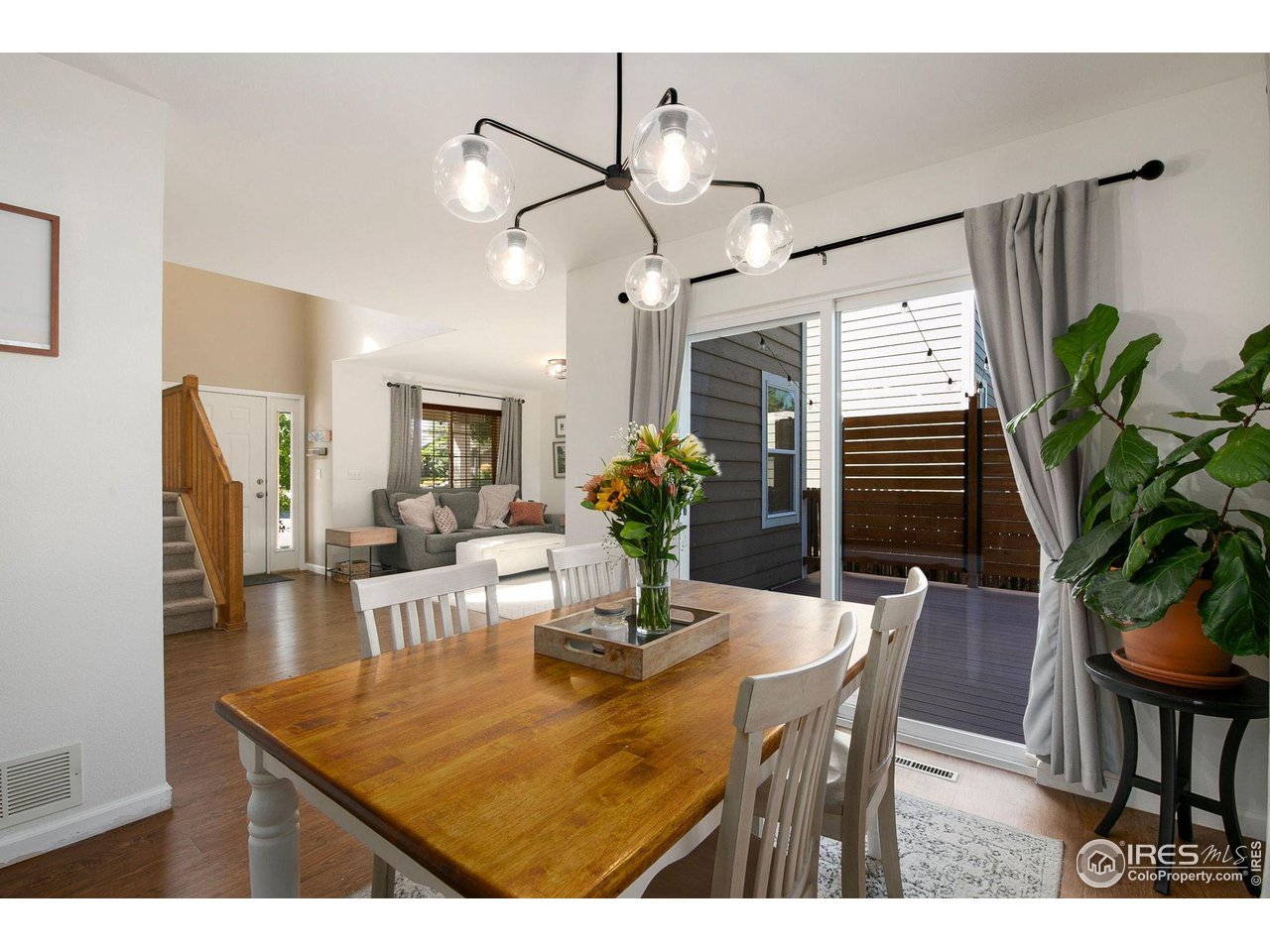 1138 Argento Drive Fort Collins, CO 80521 - Photo 7 of 25 a dining room with furniture potted plants and wooden floor