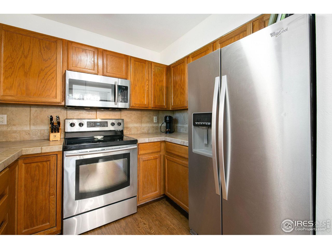 1138 Argento Drive Fort Collins, CO 80521 - Photo 10 of 25 a kitchen with stainless steel appliances a refrigerator sink and microwave