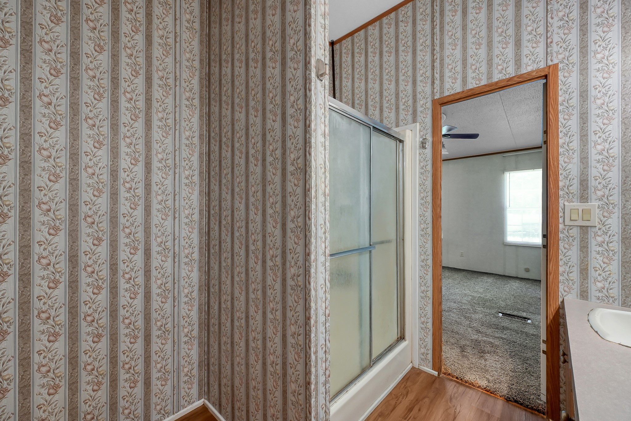 15350 Old Humble Pipeline Road Conroe, TX 77302 - Photo 15 of 38 a view of a bathroom from a hallway