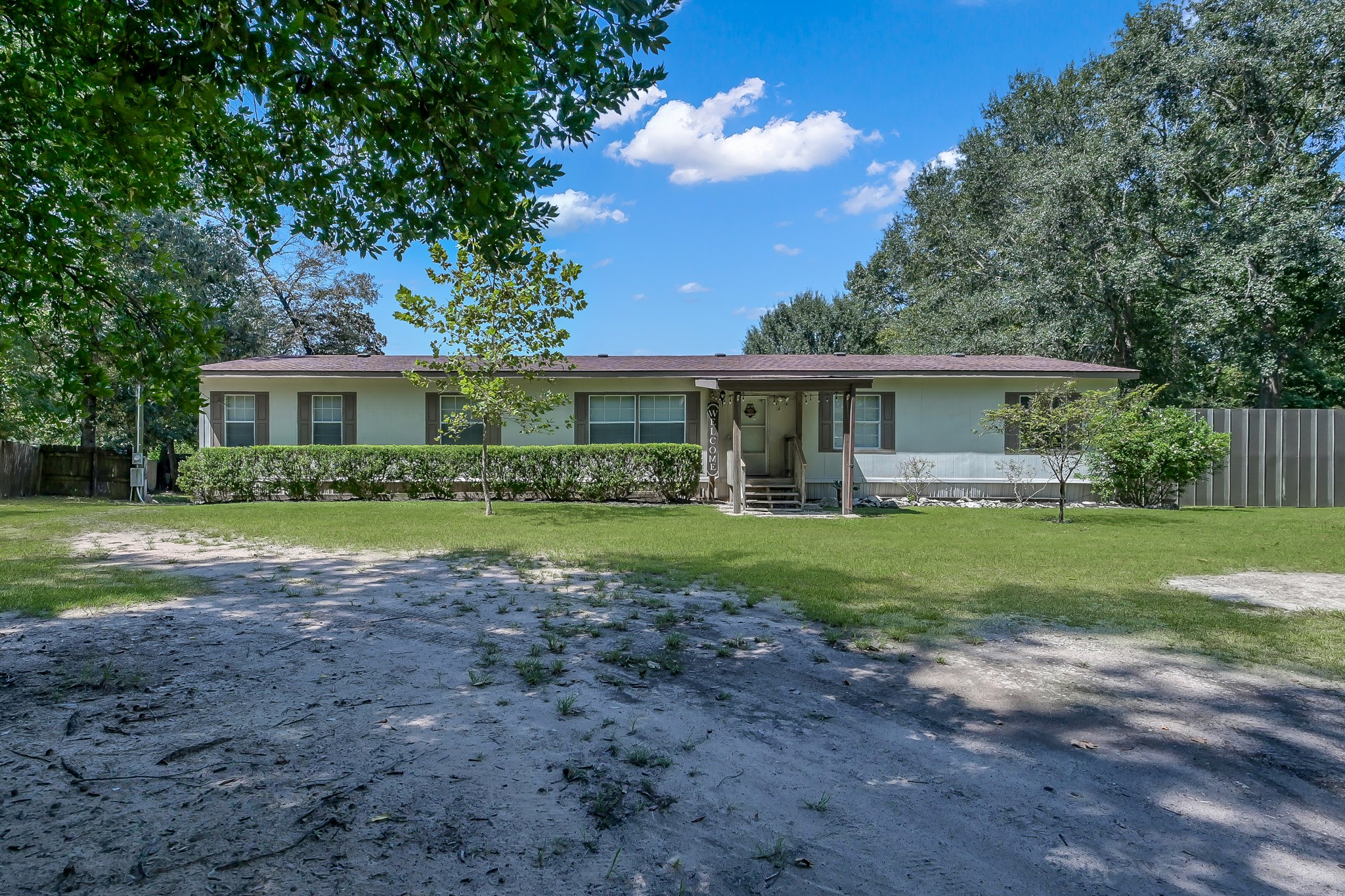 15350 Old Humble Pipeline Road Conroe, TX 77302 - Photo 2 of 38 a view of a house with a yard
