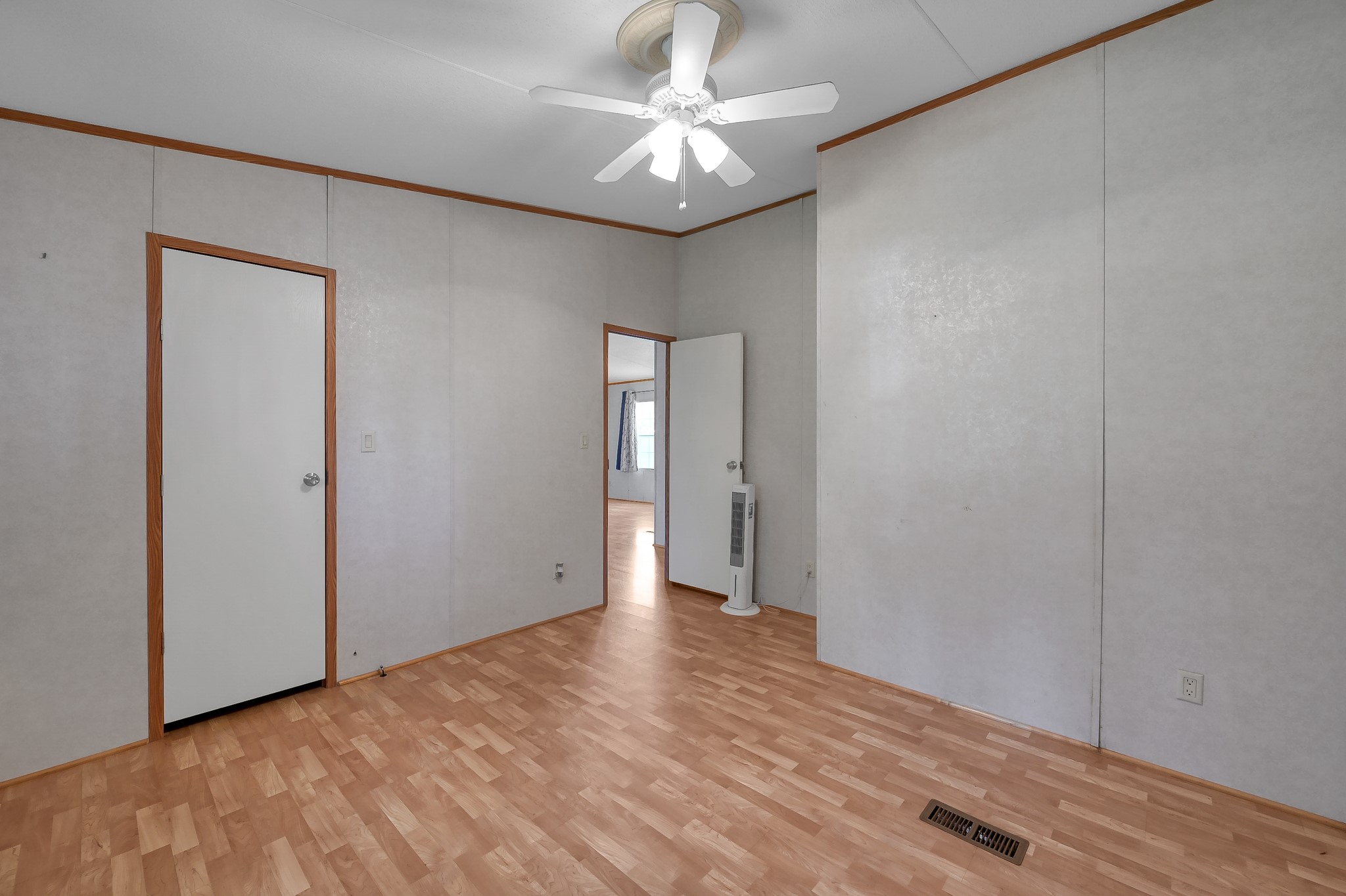 15350 Old Humble Pipeline Road Conroe, TX 77302 - Photo 24 of 38 a view of a big room with wooden floor and a chandelier fan in a room