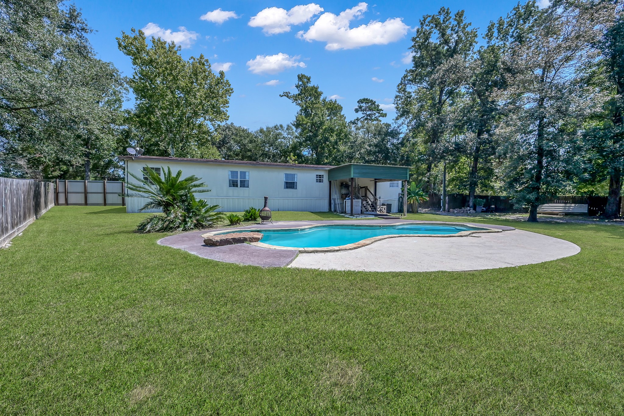 15350 Old Humble Pipeline Road Conroe, TX 77302 - Photo 26 of 38 a swimming pool with outdoor seating and yard