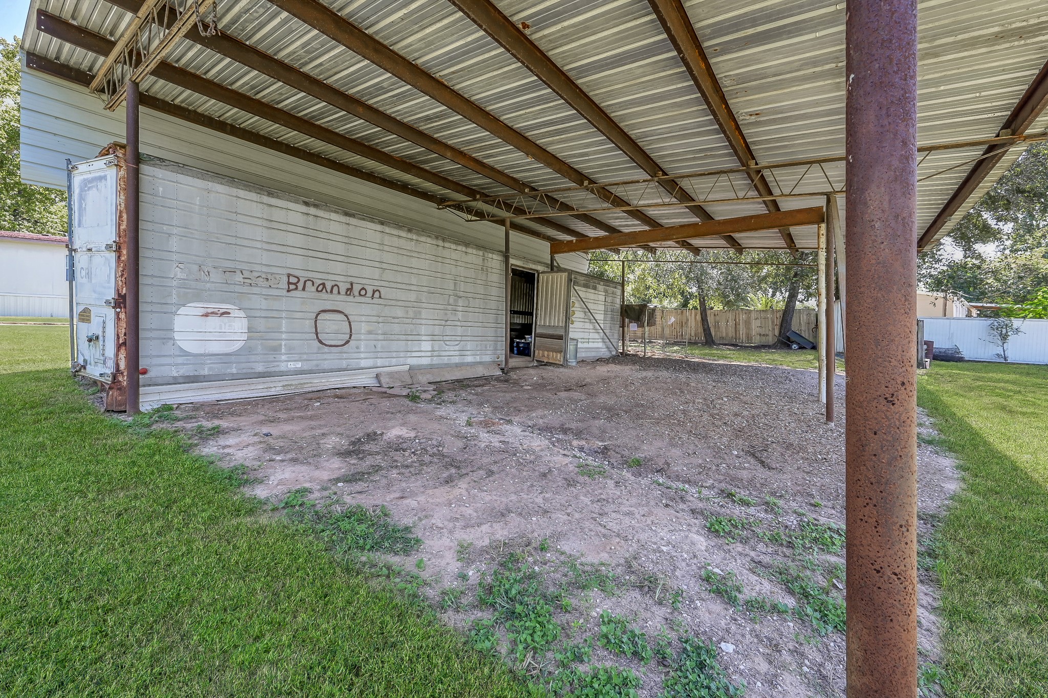 15350 Old Humble Pipeline Road Conroe, TX 77302 - Photo 29 of 38 a view of a backyard with wooden fence and large trees