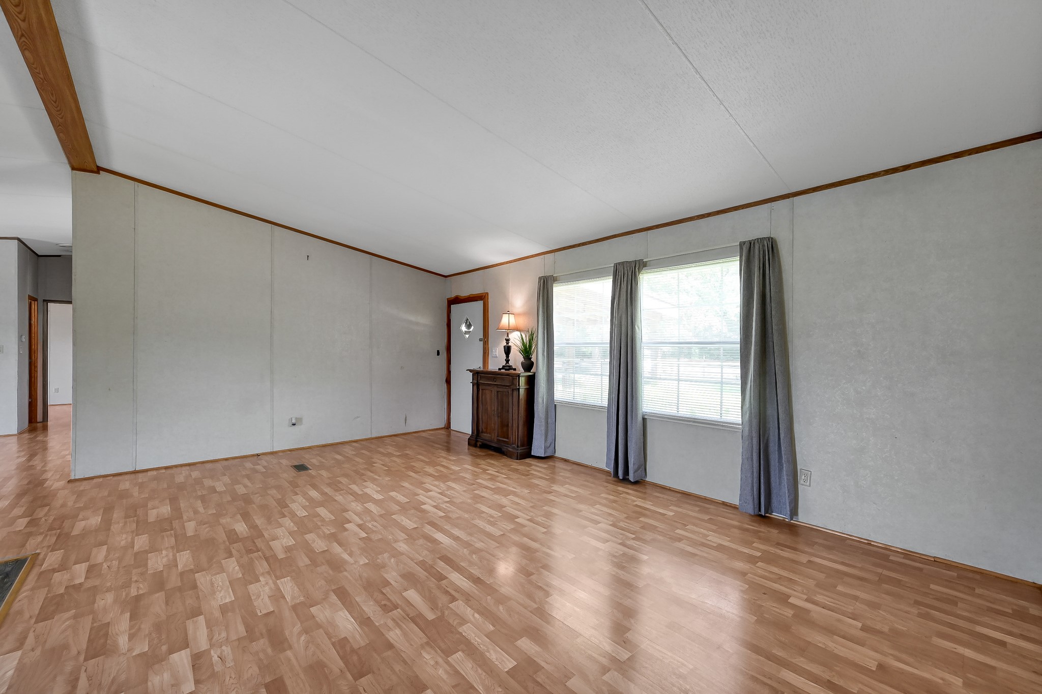 15350 Old Humble Pipeline Road Conroe, TX 77302 - Photo 3 of 38 a view of an empty room with wooden floor and a window