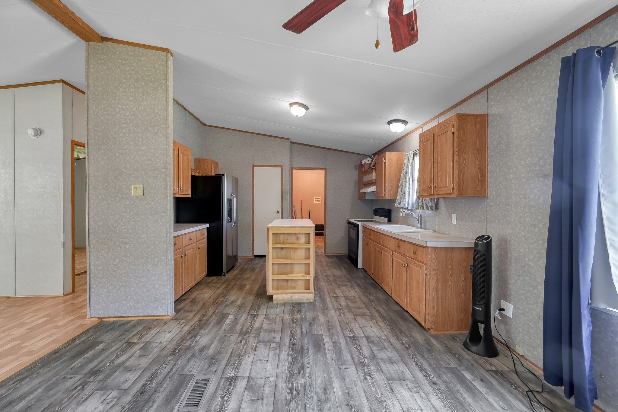 15350 Old Humble Pipeline Road Conroe, TX 77302 - Photo 5 of 38 a large kitchen with a wooden floor and cabinets