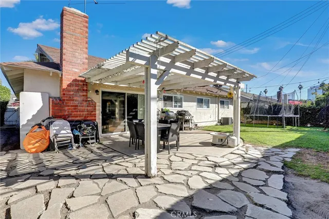 a view of a house with backyard porch and sitting area