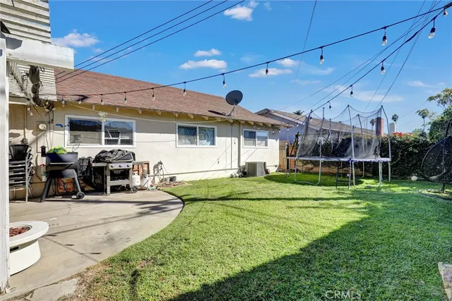 a view of a patio with dining table and chairs under an umbrella