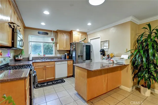 a kitchen with stainless steel appliances granite countertop a sink and a stove