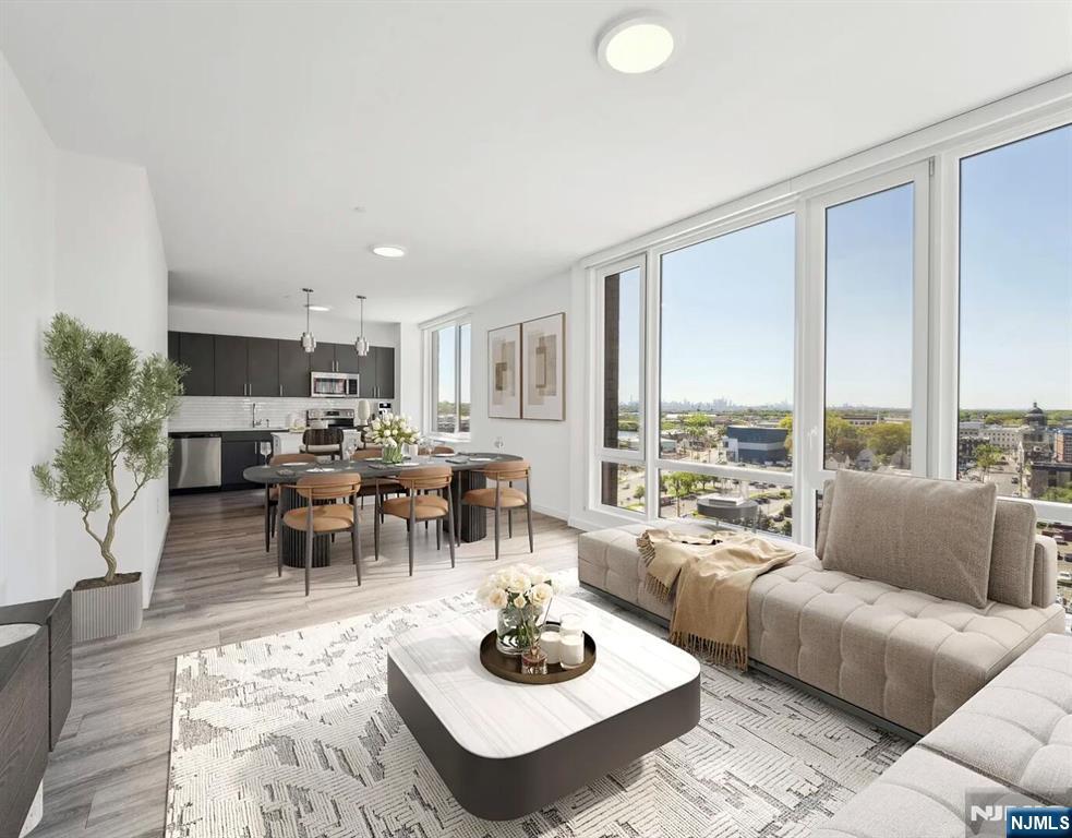 a living room with furniture potted plant and a large window