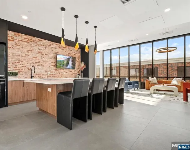 a large kitchen with kitchen island a large window a sink and counter space