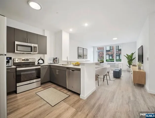 a large kitchen with a large counter top appliances and cabinets