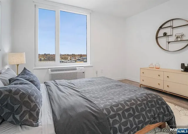 a bedroom with a bed and window