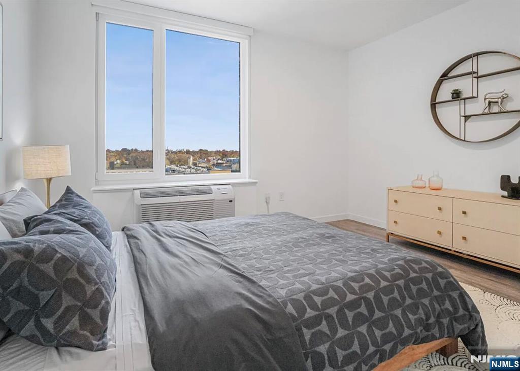 150 Main Street, Unit 405 Hackensack, NJ 07601 - Photo 8 of 12 a bedroom with a bed and window