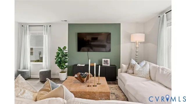 a living room with furniture and a flat screen tv