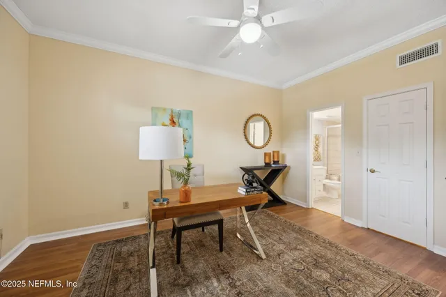 a workspace room with furniture and wooden floor