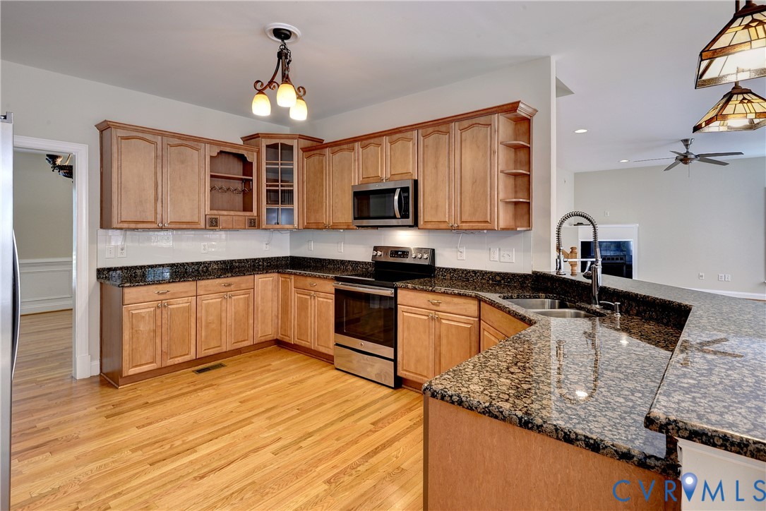 11385 Winding River Road Providence Forge, VA 23140 - Photo 18 of 43 a kitchen with granite countertop a sink a counter top space cabinets and stainless steel appliances